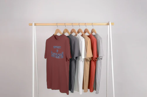 Different coloured University of Southampton t-shirts hung on a rail.